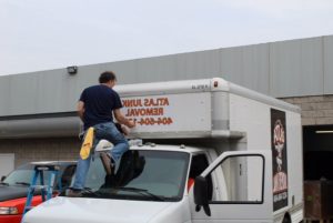 Installer applying vinyl graphics to trailer